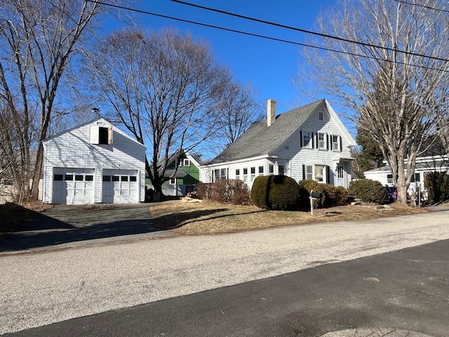 view of side of home featuring an outbuilding and a garage