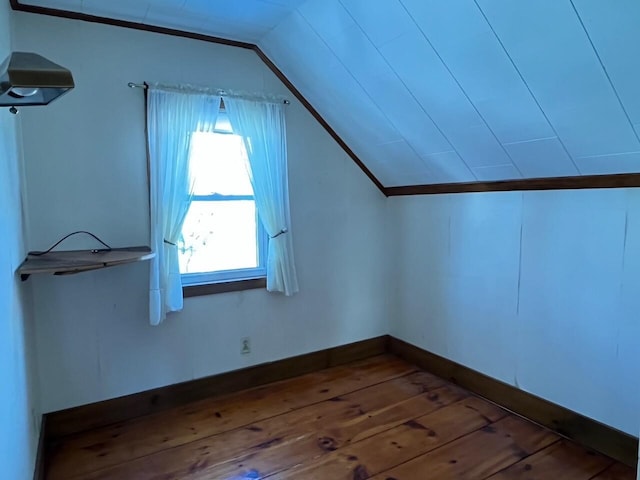 additional living space with hardwood / wood-style flooring and vaulted ceiling