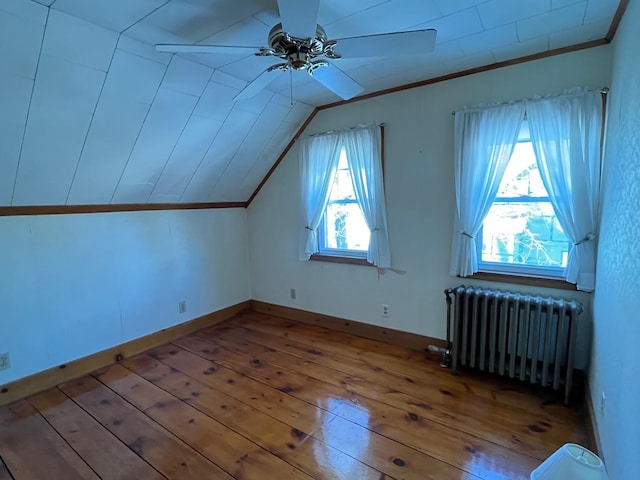 bonus room with ceiling fan, vaulted ceiling, radiator, and light hardwood / wood-style flooring