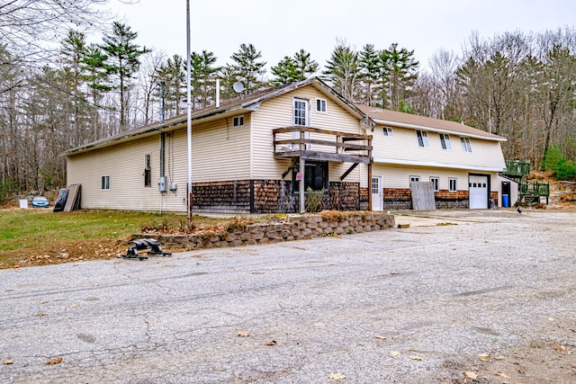 view of front of property featuring a garage and a balcony