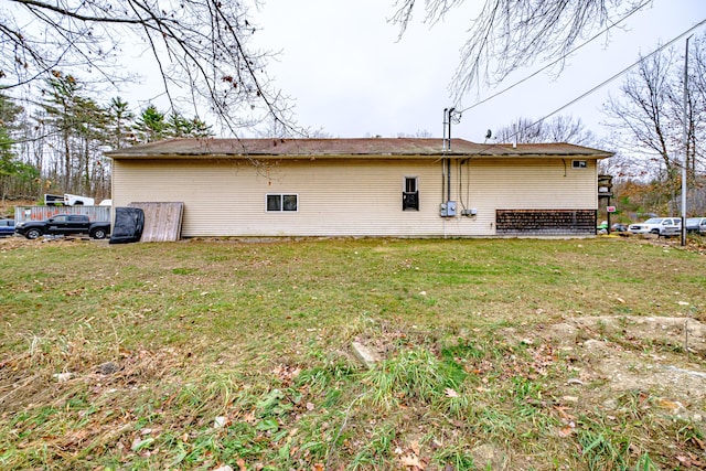 back of property featuring a lawn