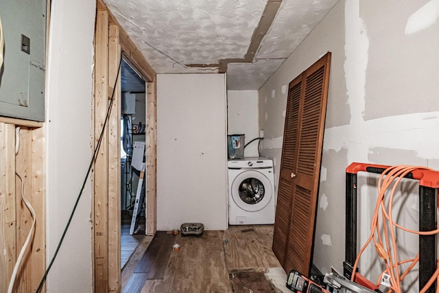 laundry area featuring washer / dryer, wood-type flooring, and a textured ceiling