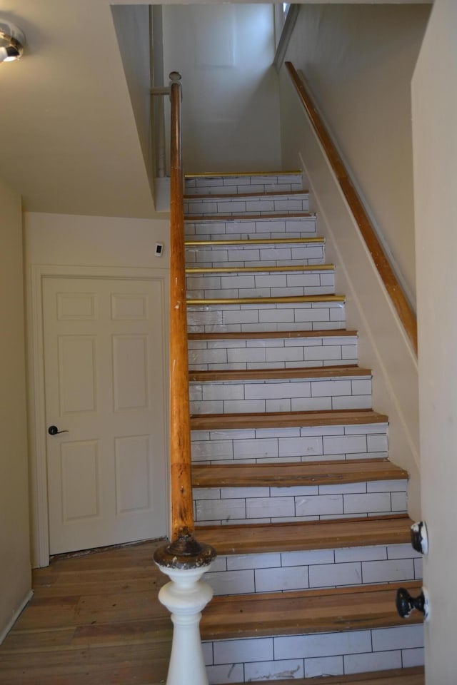 stairway with wood-type flooring