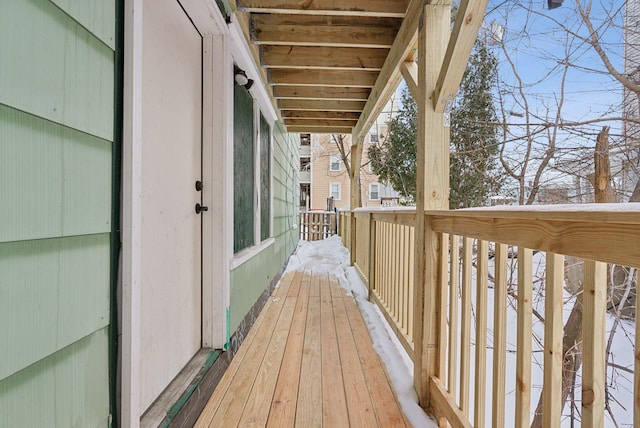 view of snow covered back of property