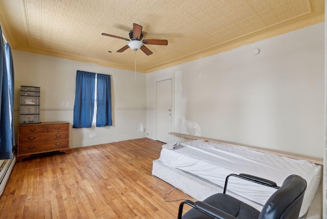 bedroom featuring ornamental molding, hardwood / wood-style floors, and ceiling fan