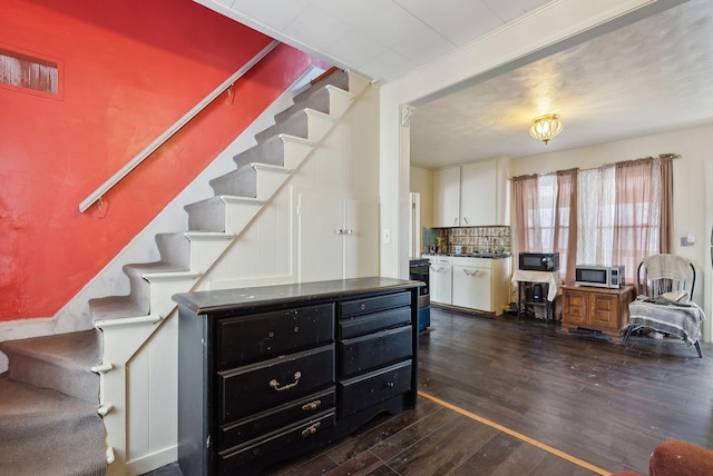 staircase with hardwood / wood-style flooring