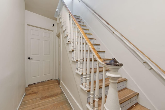 stairway featuring wood-type flooring