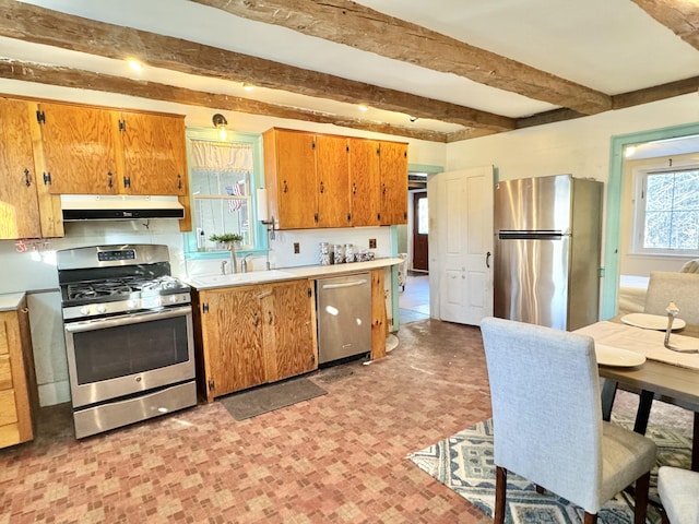 kitchen with sink, beamed ceiling, and stainless steel appliances