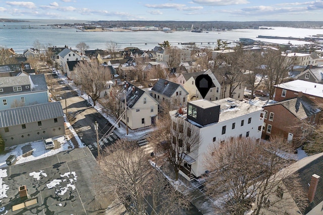 snowy aerial view featuring a water view