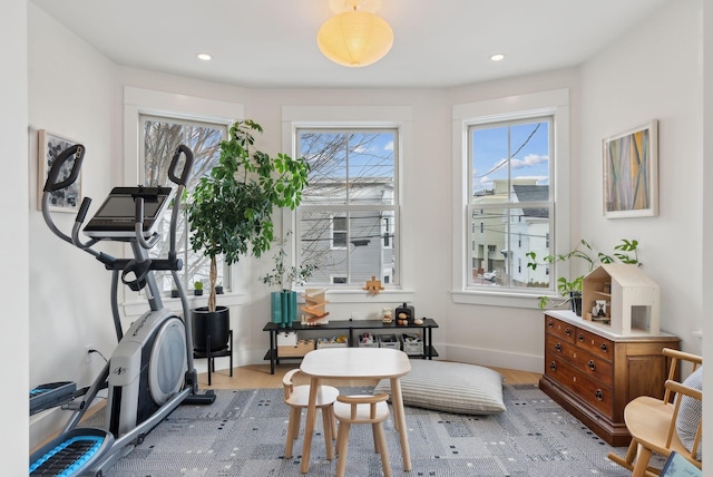 exercise room featuring light wood-type flooring