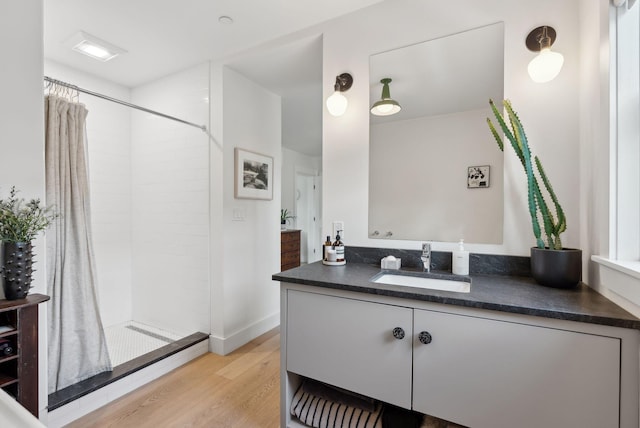 bathroom featuring hardwood / wood-style floors, vanity, and a shower with curtain