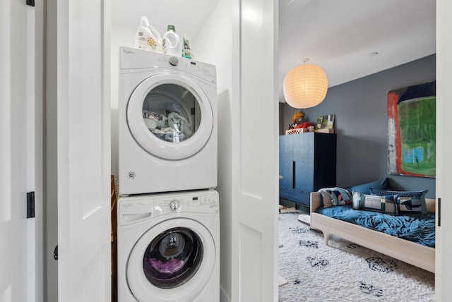 washroom featuring stacked washer and dryer