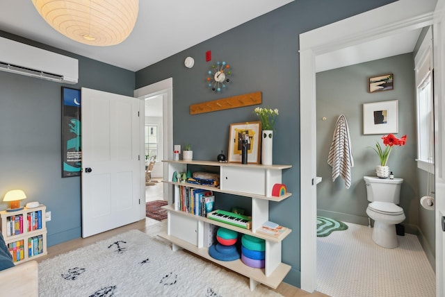 recreation room with a wall mounted air conditioner