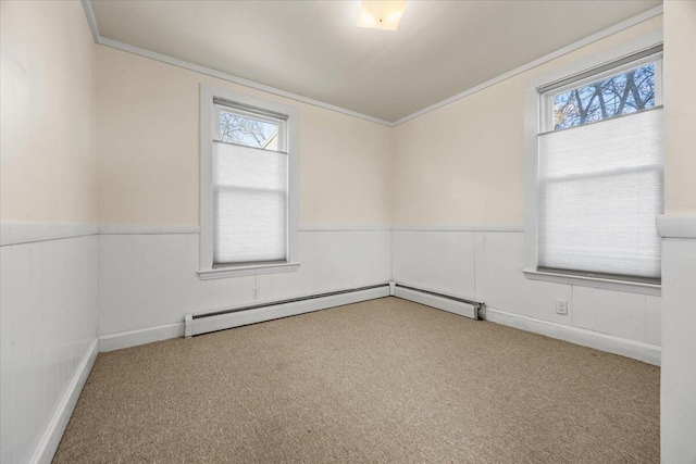 unfurnished room with crown molding, plenty of natural light, light colored carpet, and baseboard heating