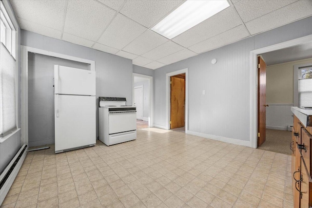 kitchen with a paneled ceiling, white appliances, and baseboard heating