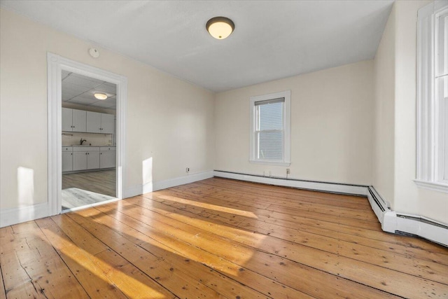 unfurnished bedroom featuring connected bathroom and hardwood / wood-style flooring