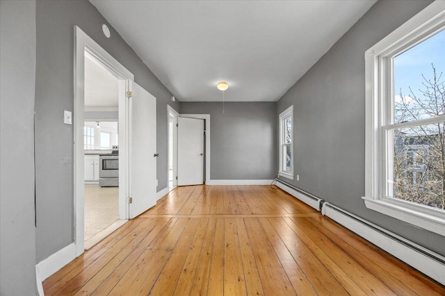 interior space with light wood-type flooring and baseboard heating