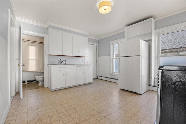 kitchen with white cabinetry, baseboard heating, white fridge, and crown molding