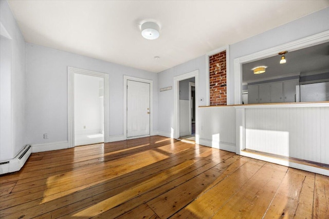 interior space featuring hardwood / wood-style flooring, a baseboard radiator, and radiator heating unit