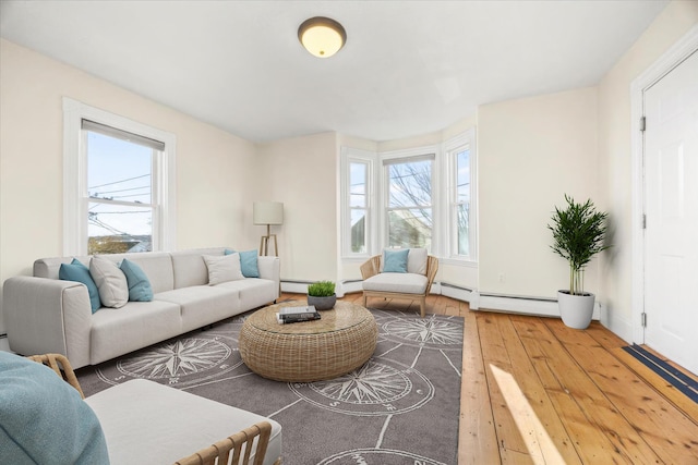 living room featuring baseboard heating and hardwood / wood-style floors