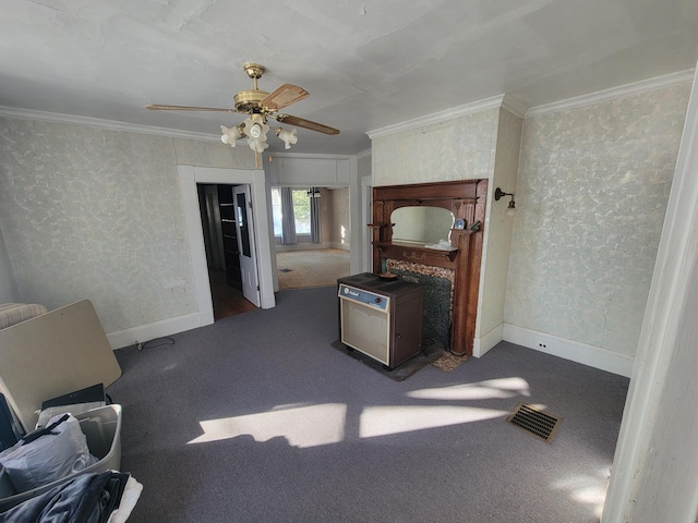 kitchen with ceiling fan, dark carpet, and ornamental molding