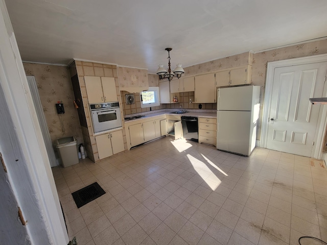 kitchen with a notable chandelier, white appliances, hanging light fixtures, crown molding, and cream cabinets