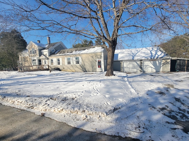 snow covered property featuring a garage