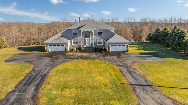 view of front of house with a front yard and a garage