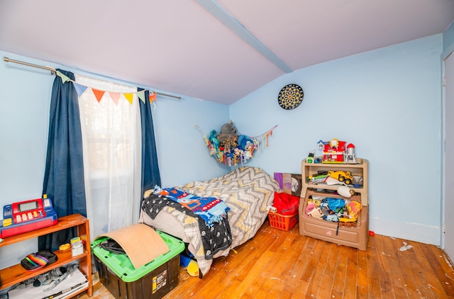 bedroom featuring lofted ceiling and hardwood / wood-style floors