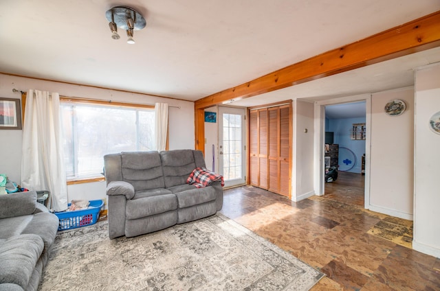 living room featuring beamed ceiling