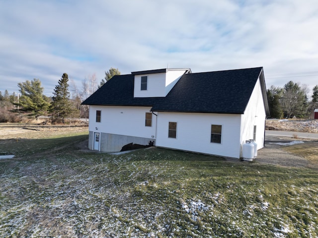 rear view of property with a lawn