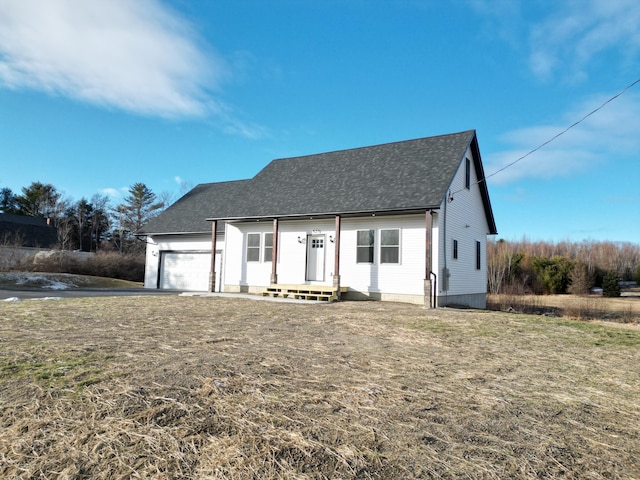 view of front of property with a garage and a front lawn