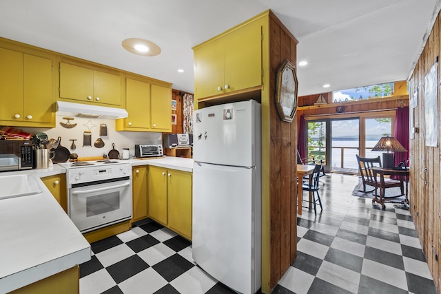 36 Storer Rd, Bremen, ME 04551 - kitchen with white appliances, tile patterned floors, under cabinet range hood, light countertops, and wood walls