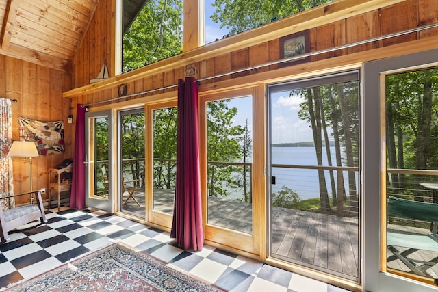 36 Storer Rd, Bremen, ME 04551 - entryway with tile patterned floors, healthy amount of natural light, wood walls, a water view, and wooden ceiling