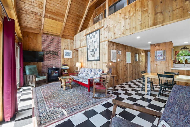 36 Storer Rd, Bremen, ME 04551 - living room with wood walls, tile patterned floors, a wood stove, a wooden ceiling with exposed beams, and recessed lighting