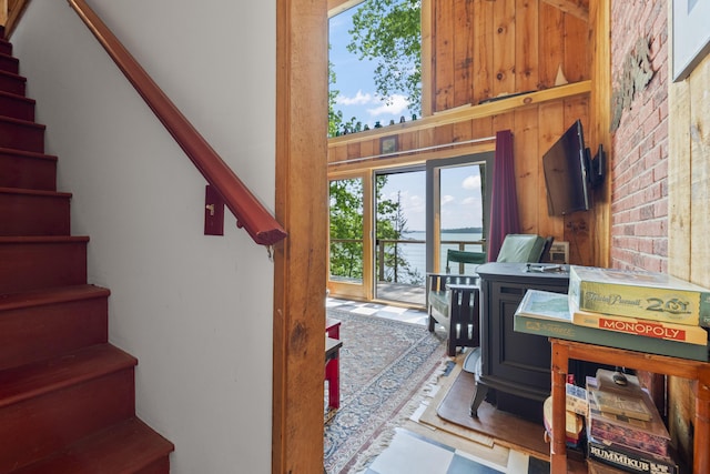 36 Storer Rd, Bremen, ME 04551 - staircase featuring a wood stove and wooden walls