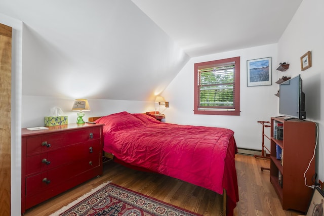 36 Storer Rd, Bremen, ME 04551 - bedroom with wood finished floors, lofted ceiling, and a baseboard radiator