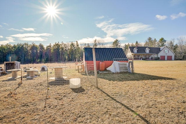 view of play area featuring a rural view, a lawn, and an outdoor structure