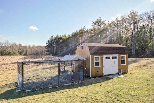 view of outbuilding with a yard