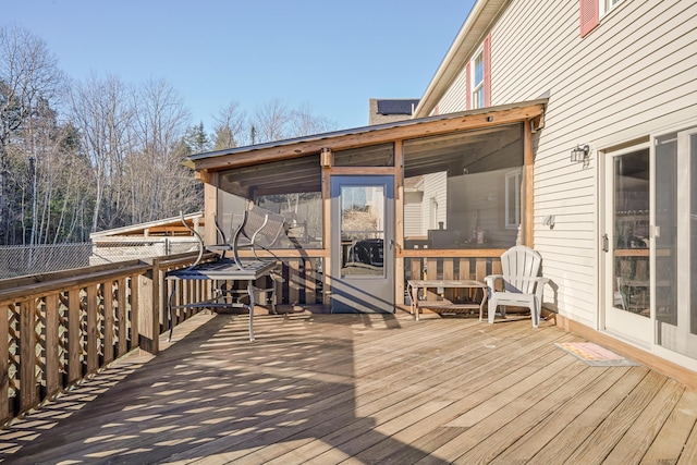 wooden deck featuring a sunroom