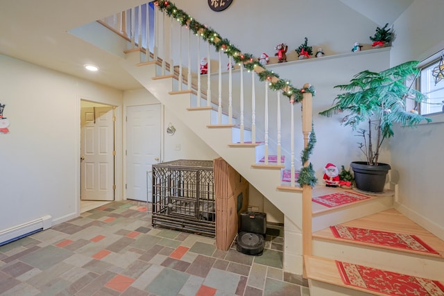 stairway with a baseboard radiator