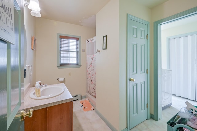 bathroom with a shower with shower curtain, vanity, and baseboard heating