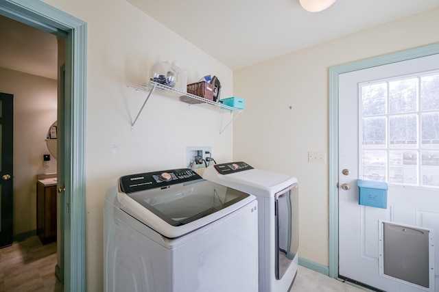 laundry room with washer and clothes dryer and hardwood / wood-style floors