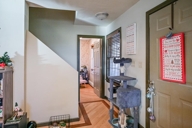 hallway with light hardwood / wood-style flooring