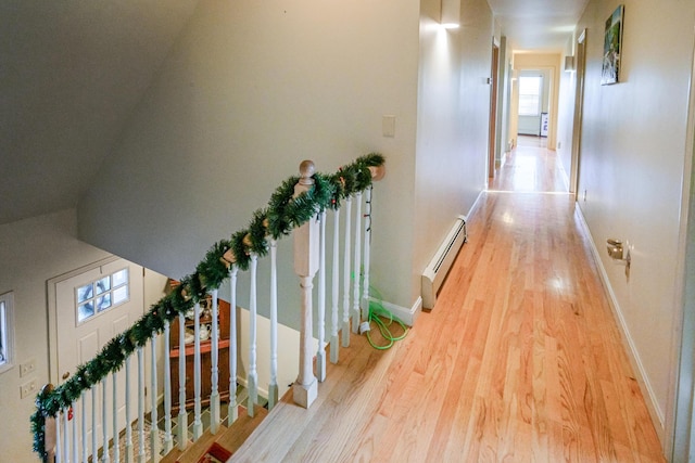 hallway with baseboard heating and light wood-type flooring