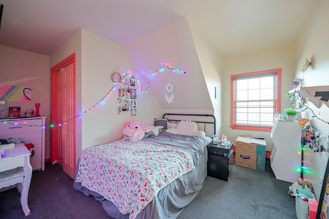 bedroom with a closet and dark carpet