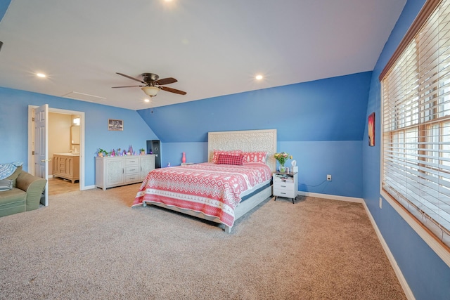 carpeted bedroom featuring ceiling fan, ensuite bathroom, and lofted ceiling