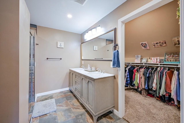 bathroom featuring walk in shower and vanity