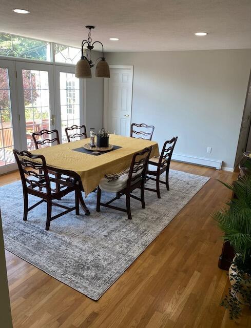 dining area featuring a notable chandelier and hardwood / wood-style flooring