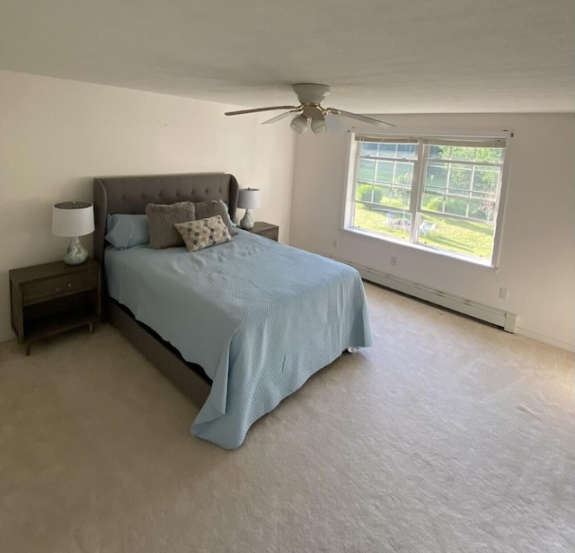 bedroom featuring a baseboard radiator, light carpet, and ceiling fan